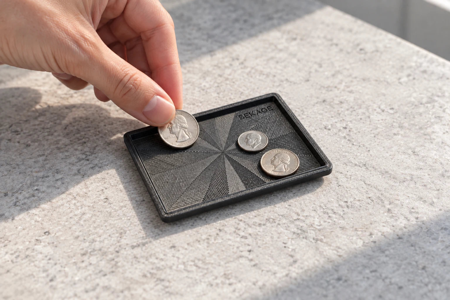 The Sekage Coin Tray holding coins
